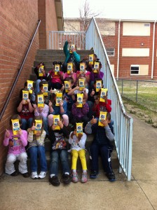 students sitting on stairs holding gifts from TeacherLists