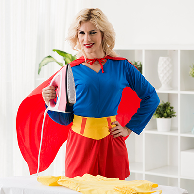 woman dressed as superwoman with an iron