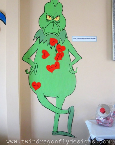 grinch cutout with hearts pinned to it