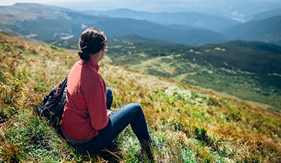 woman sitting on a hill