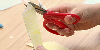 Child using Fiskars scissors