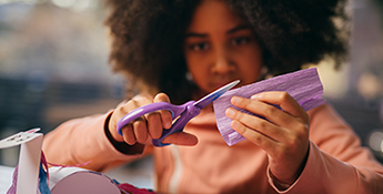 Boy using Fiskars scissors